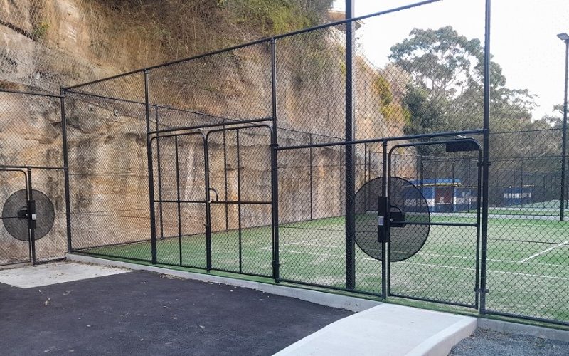 Tennis court with access via two gates
